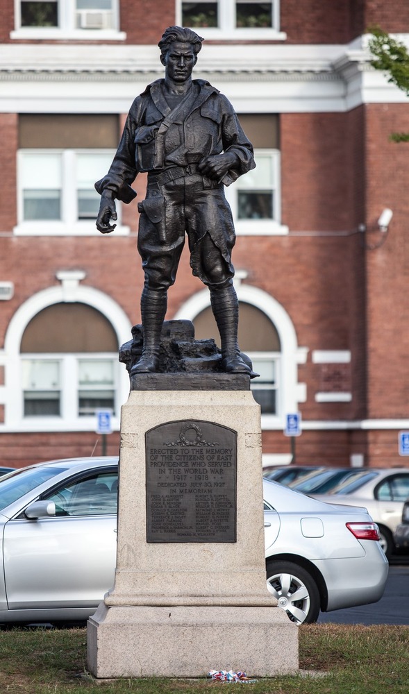 Bronze statue of a World War I soldier at the East Providence Memorial, honoring local veterans in a park setting served by Pro Mosquito Solutions' pest control.