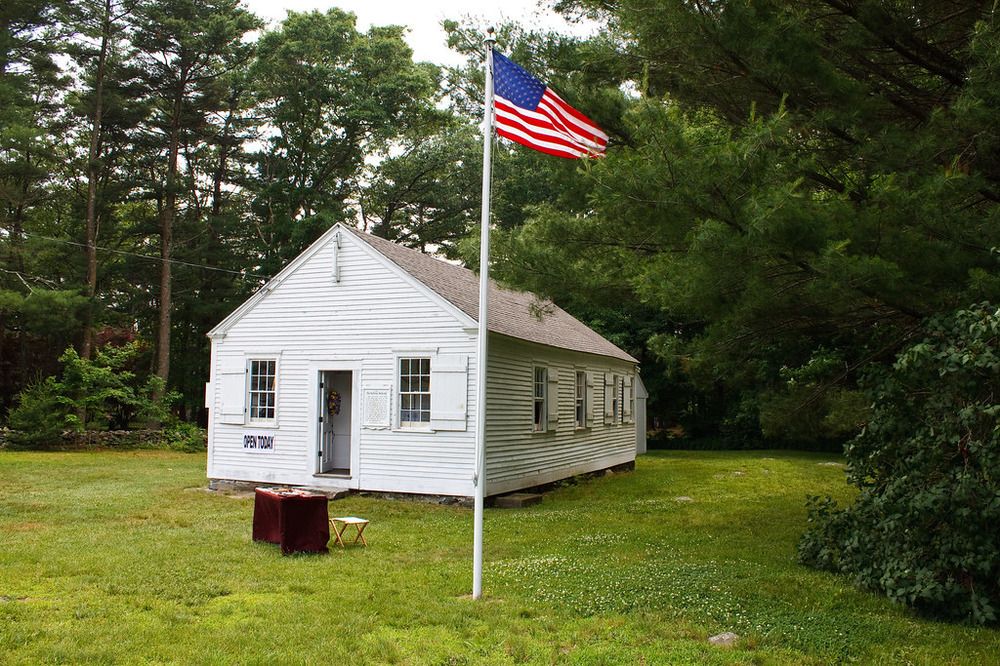 Historic Horbine School, a 19th-century one-room schoolhouse in Swansea, MA, with a rustic wooden exterior and traditional architecture.