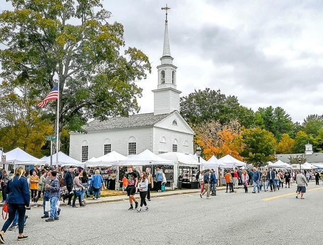 Lively scene at the Scituate Art Festival with booths displaying local crafts and artwork, visitors browsing, and fall foliage in the background.