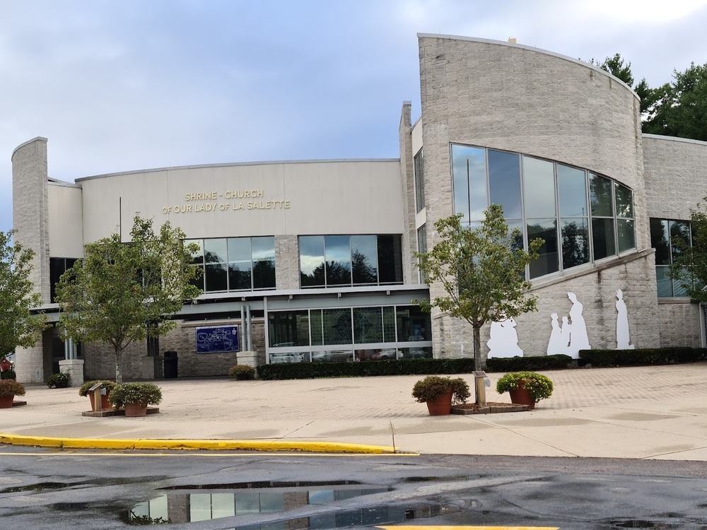 National Shrine of Our Lady of La Salette in Attleboro, MA, showcasing grand architecture and serene greenery, within Pro Mosquito Solutions pest control service area.