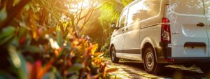 A professional exterminator in a crisp uniform assessing pest control needs in a lush Rhode Island garden, surrounded by greenery and common pests like mosquitoes and termites.