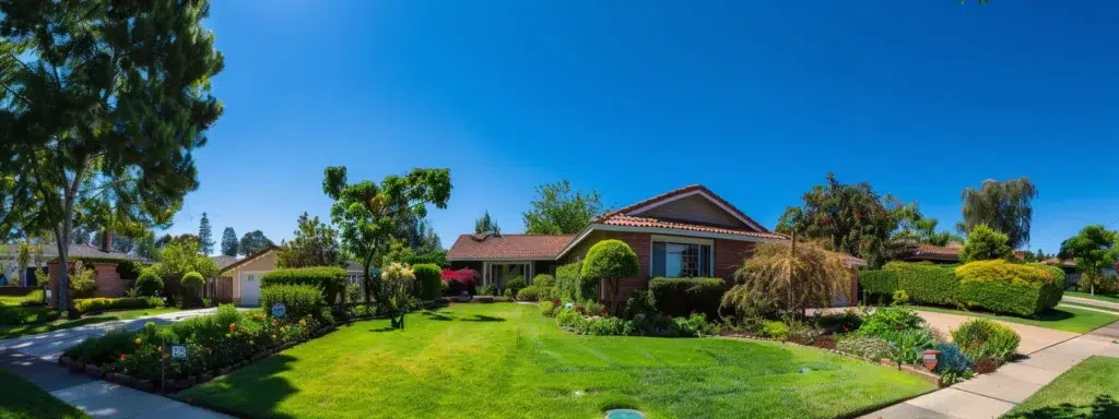 A serene suburban home under a clear blue sky, featuring an expertly applied foundation pest protection barrier, surrounded by lush gardens and well-maintained landscaping, symbolizing proactive defense against ants, spiders, and rodents.